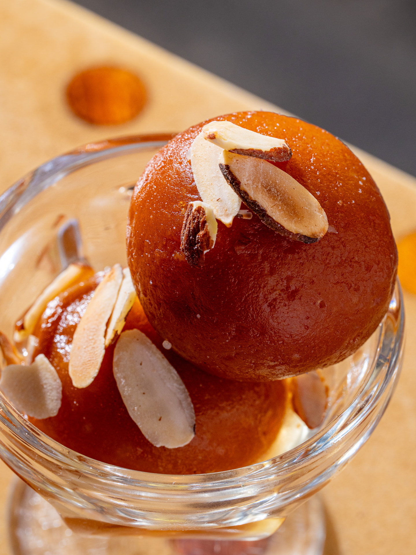 Gulab jamun with sliced almonds, close up