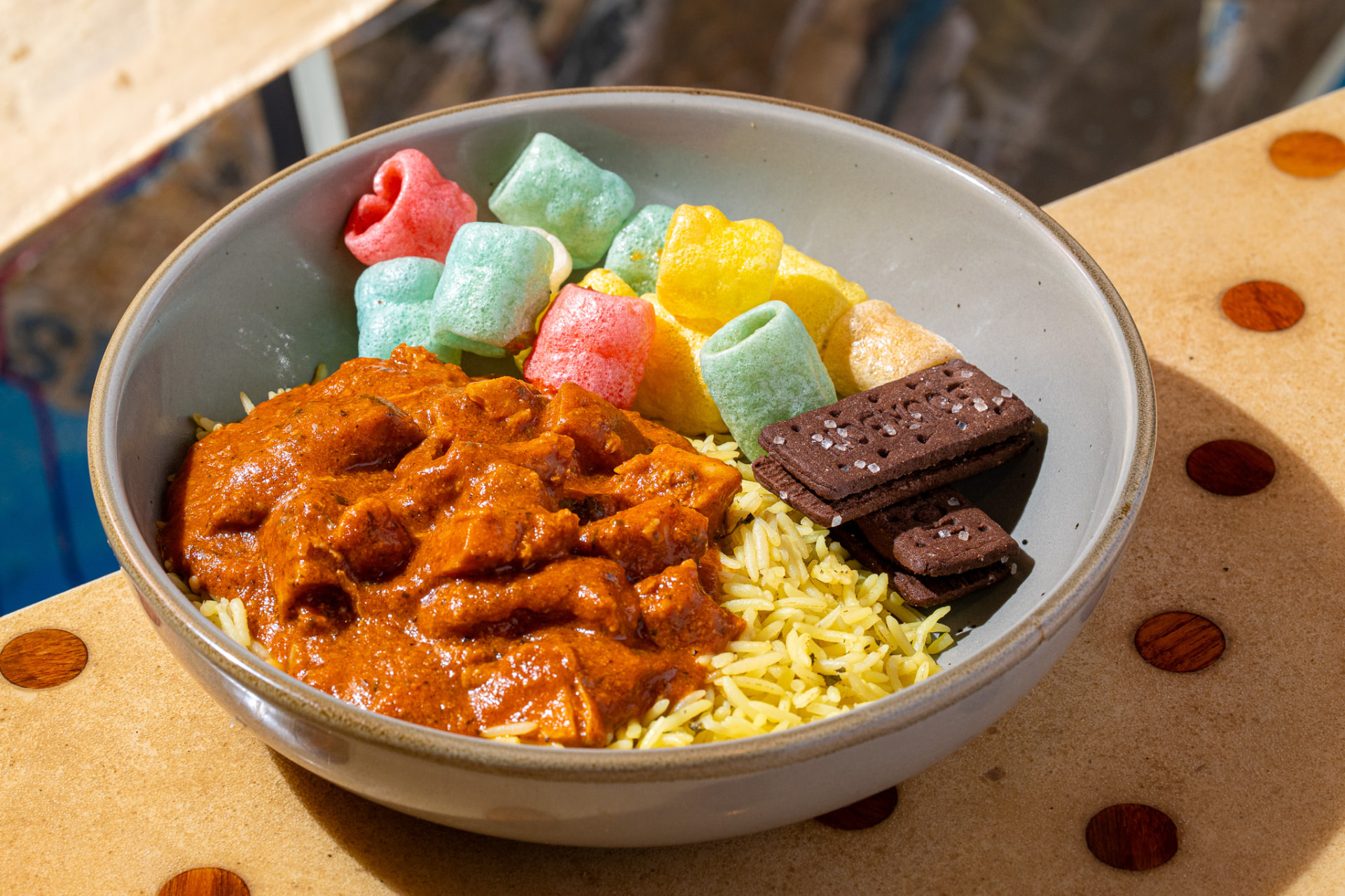 Kids tikka masala bowl with turmeric rice, fryums and a bourbon biscuit