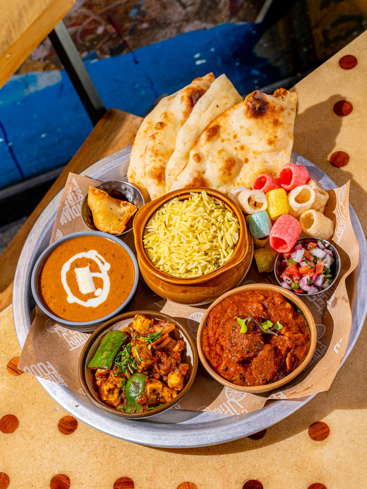 Thali platter with naan, rice, daal, paneer, tikka masala, samosa, sago papad and pico