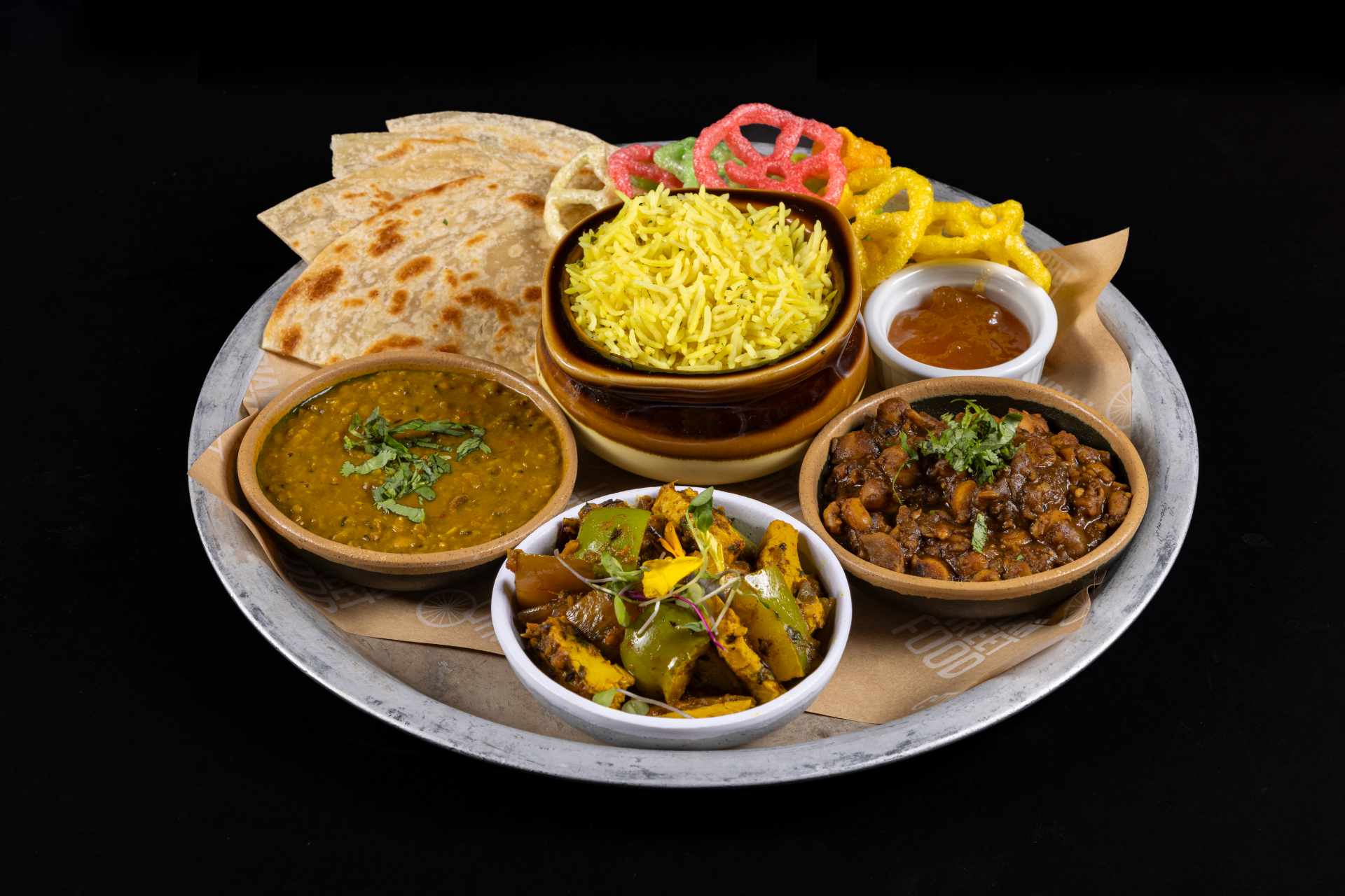 Thali angled: dal, channa, aloo gobi, turmeric rice, roti, chutney