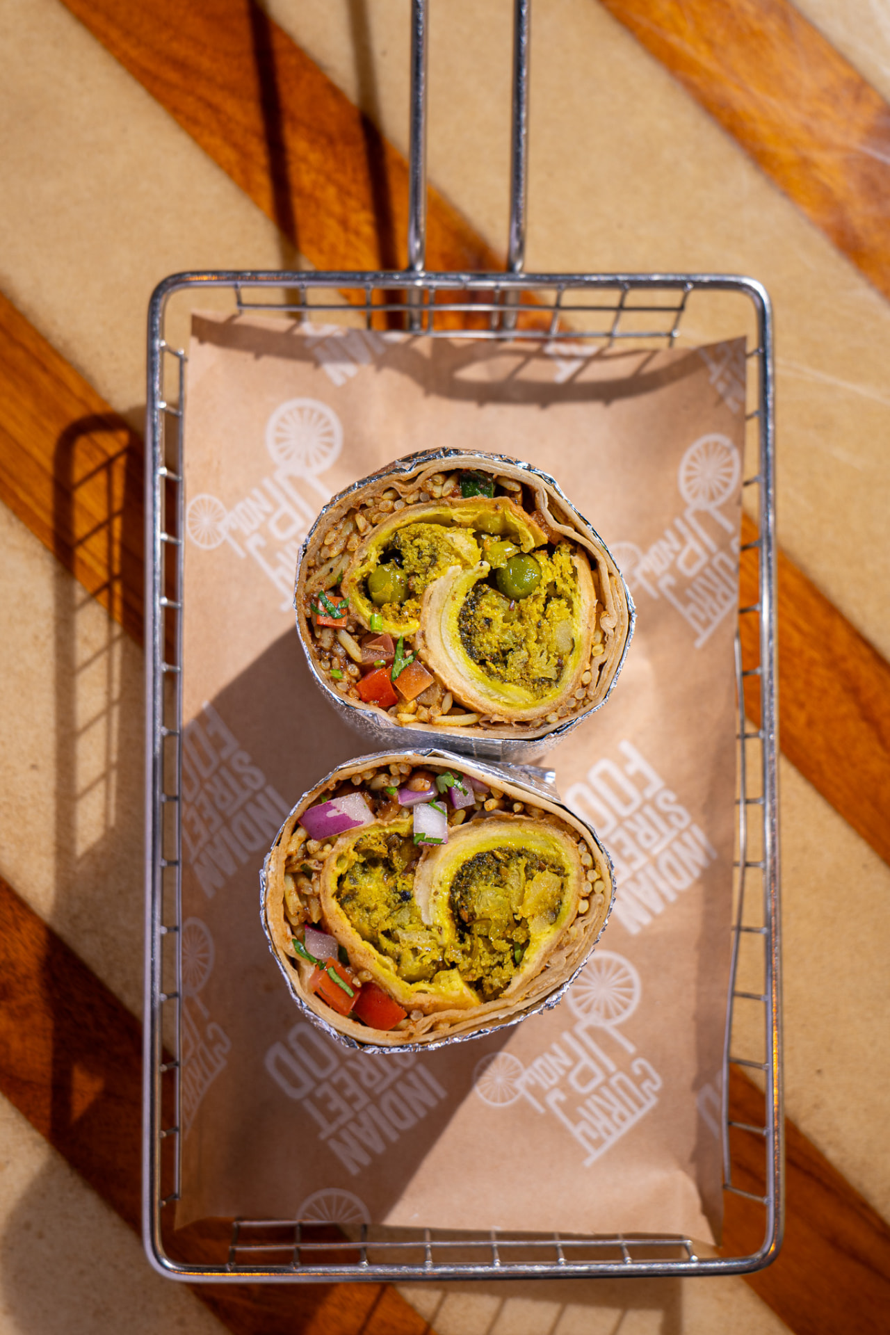 Hella Vegan burrito on branded paper
