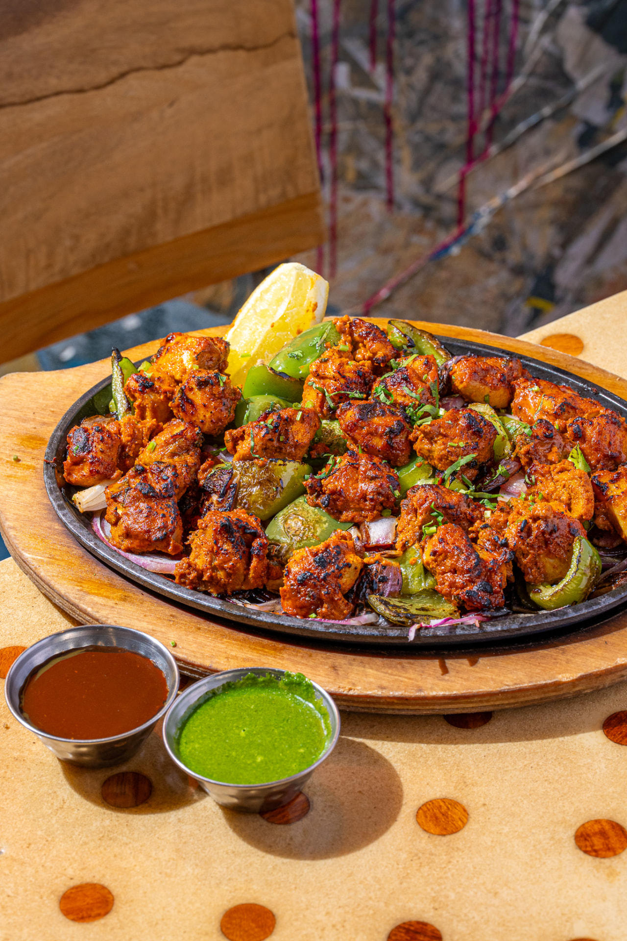 Sizzlin Kabab platter with peppers, onions, lemon and chutneys