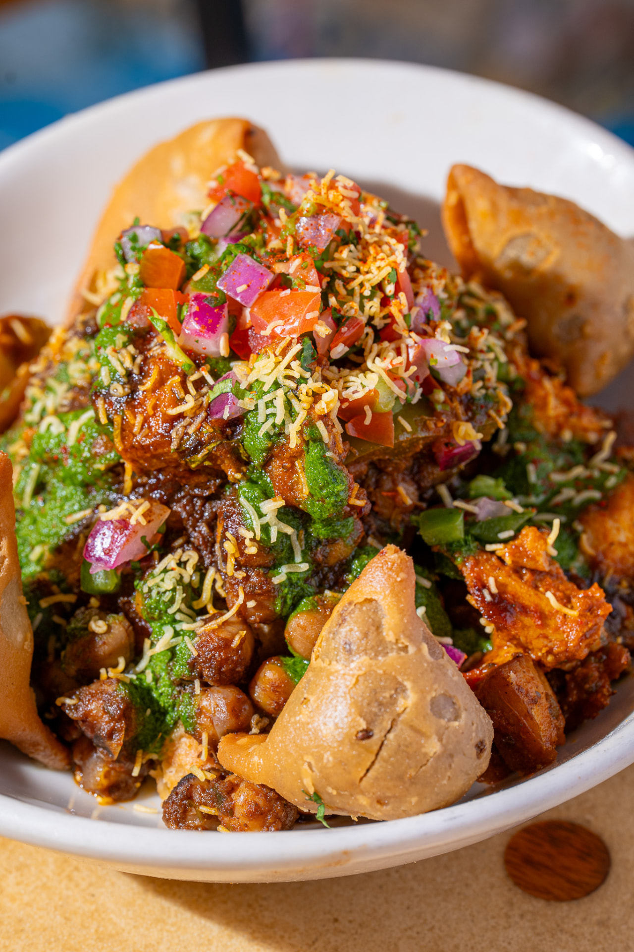 Deconstructed Samosa bowl, close up on chana, pico and sev