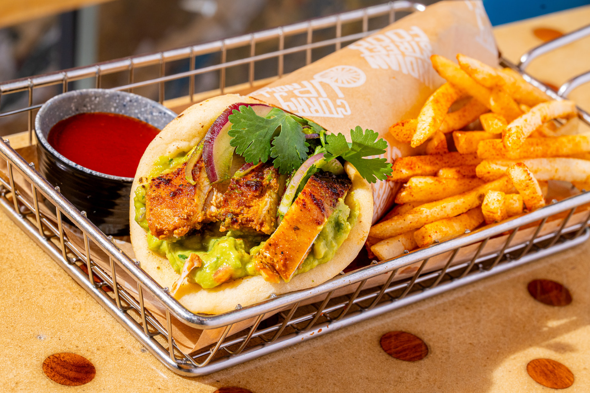 El Jefe basket with peri-peri fries and hot sauce, wide