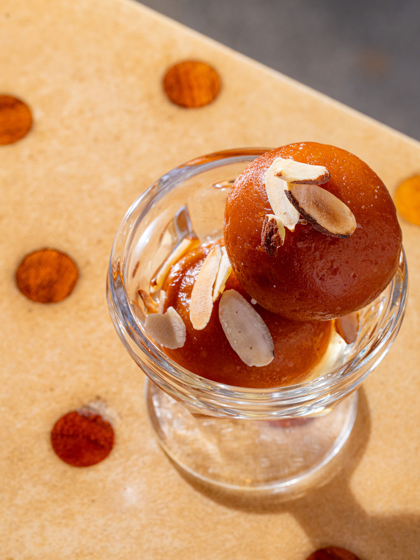 Gulab jamun in a coupe glass, overhead