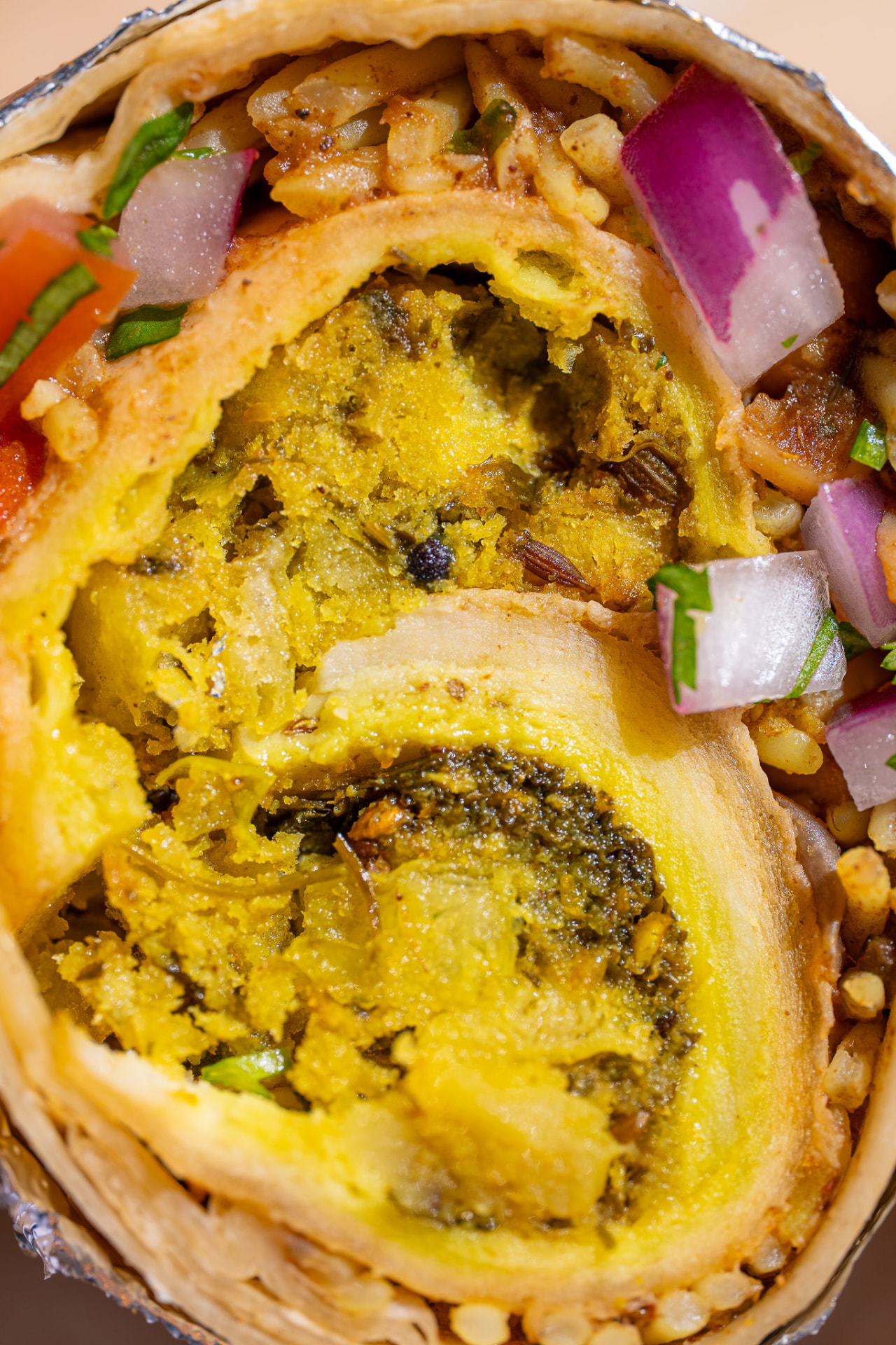 Hella Vegan burrito, macro with onion and tomato
