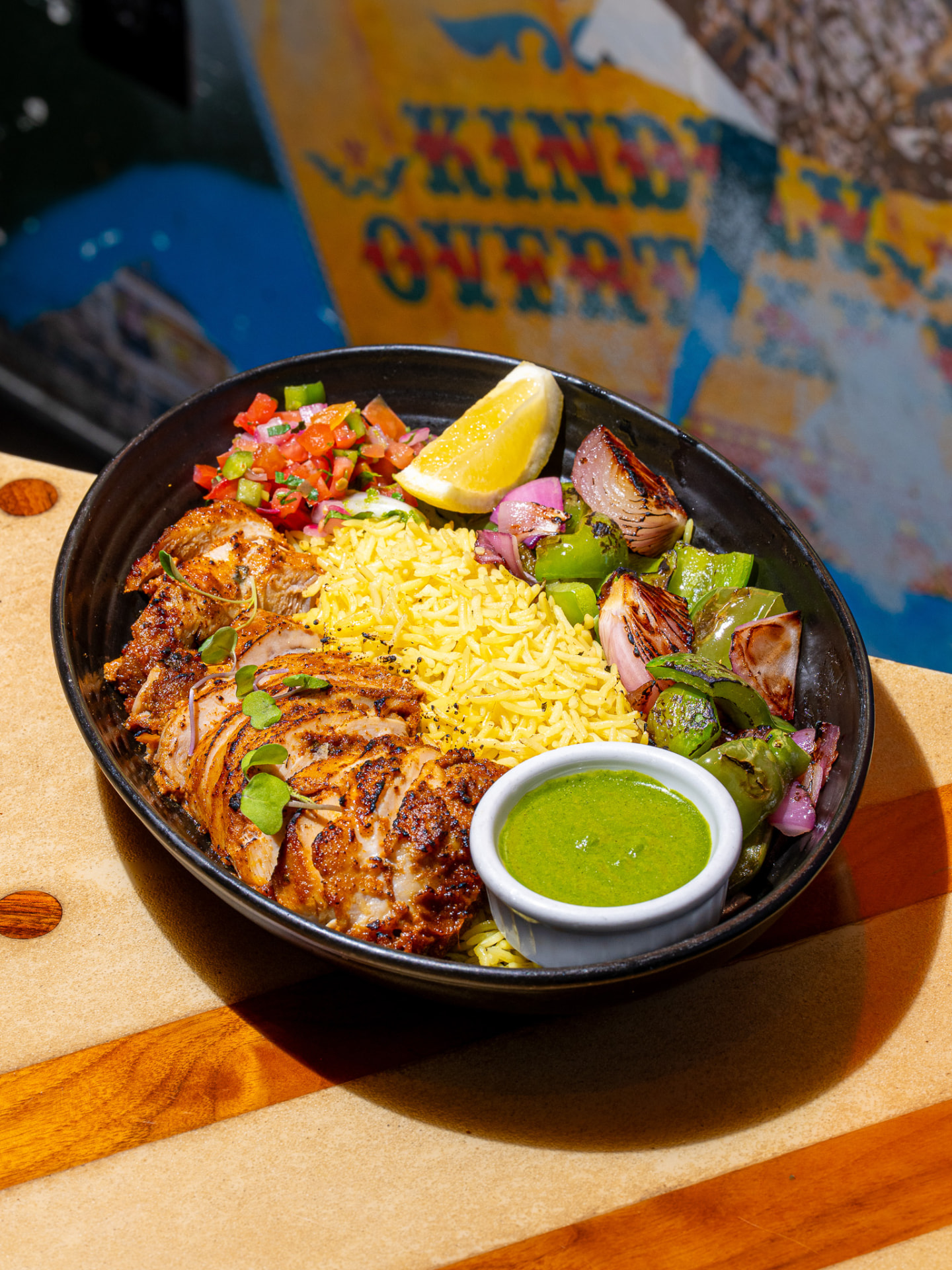 550 bowl: grilled chicken, turmeric rice, charred peppers and onions, pico, cilantro chutney, lemon