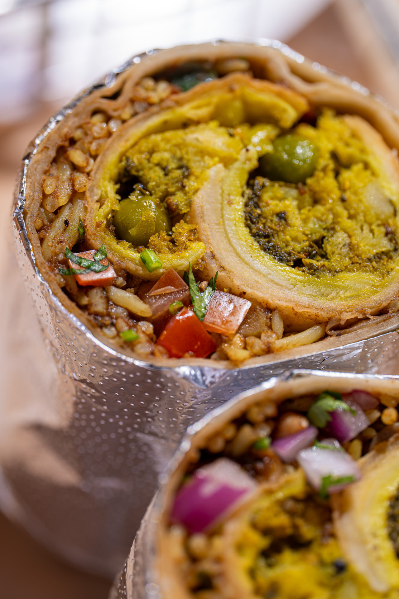 Hella Vegan burrito, cut face with peas and potato